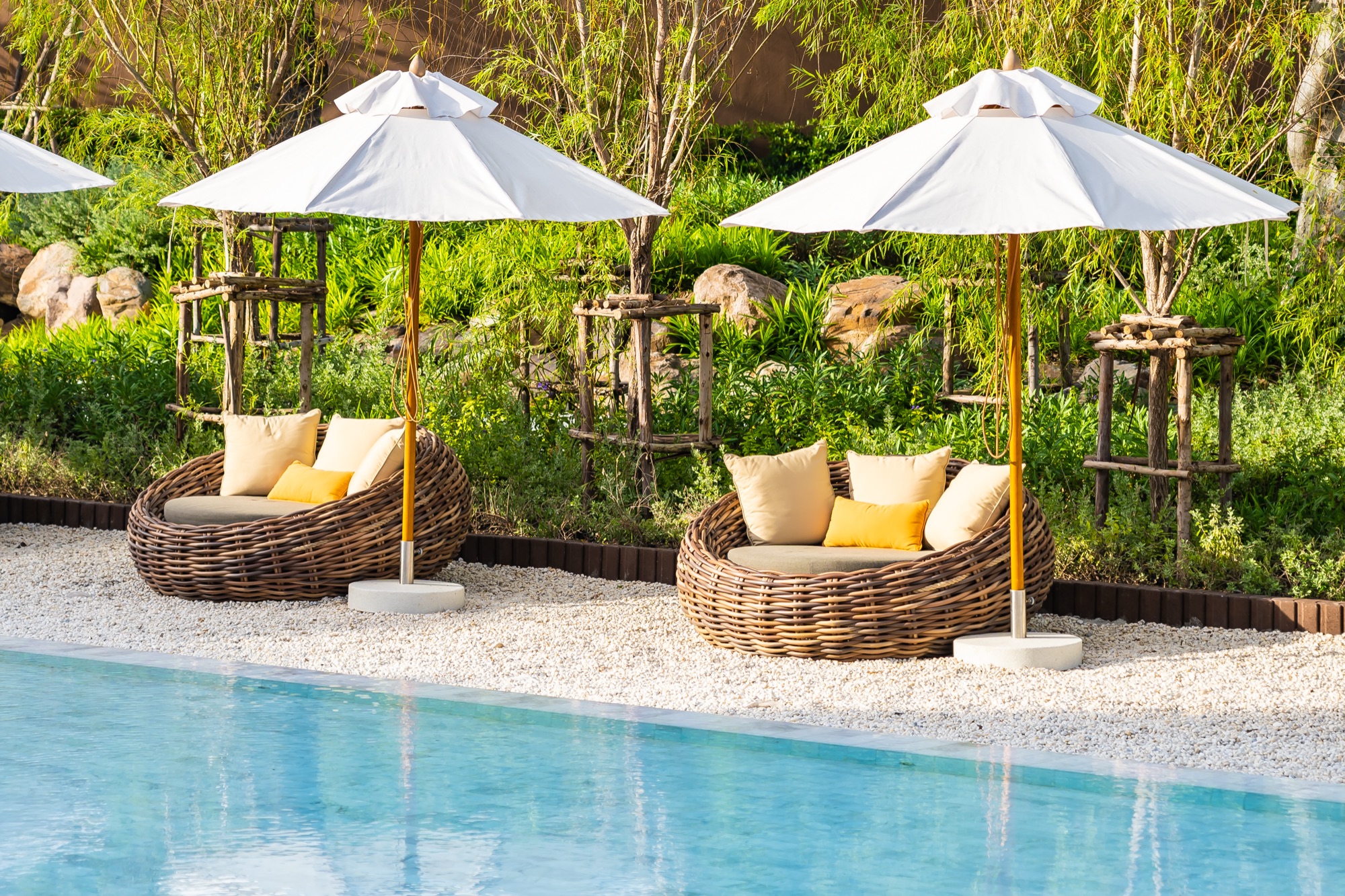 Pool loungers overlooking the ocean at a hotel resort